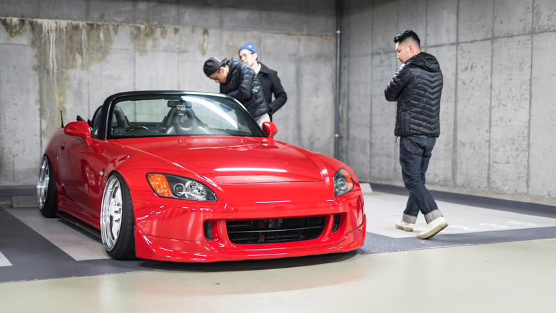 People appreciating cars